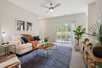 A living room with a couch and a ceiling fan